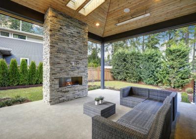 Chic Patio Design With Vaulted Ceiling And Stone Fireplace